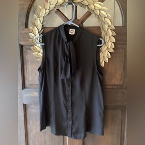 Super soft, like silk- sleeveless button up top with tie at neck.